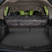 Meadowlark cargo liner rolled up and hanging on vehicle backseats in trunk.
